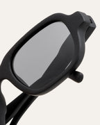 Close-up of Ochis Brade sunglasses, highlighting the refined details and smooth finish of the coffee-based frame