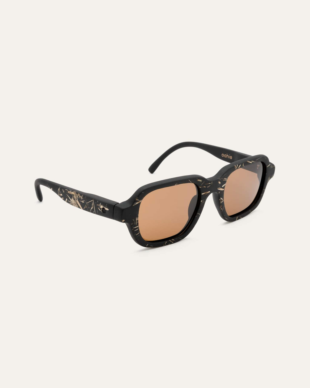 Angled view of black sunglasses with flax details and brown lenses.