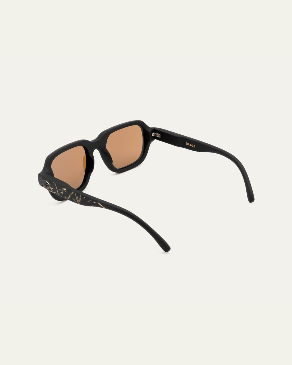 Side view of black frame sunglasses with brown lenses, bold sunglasses construction.