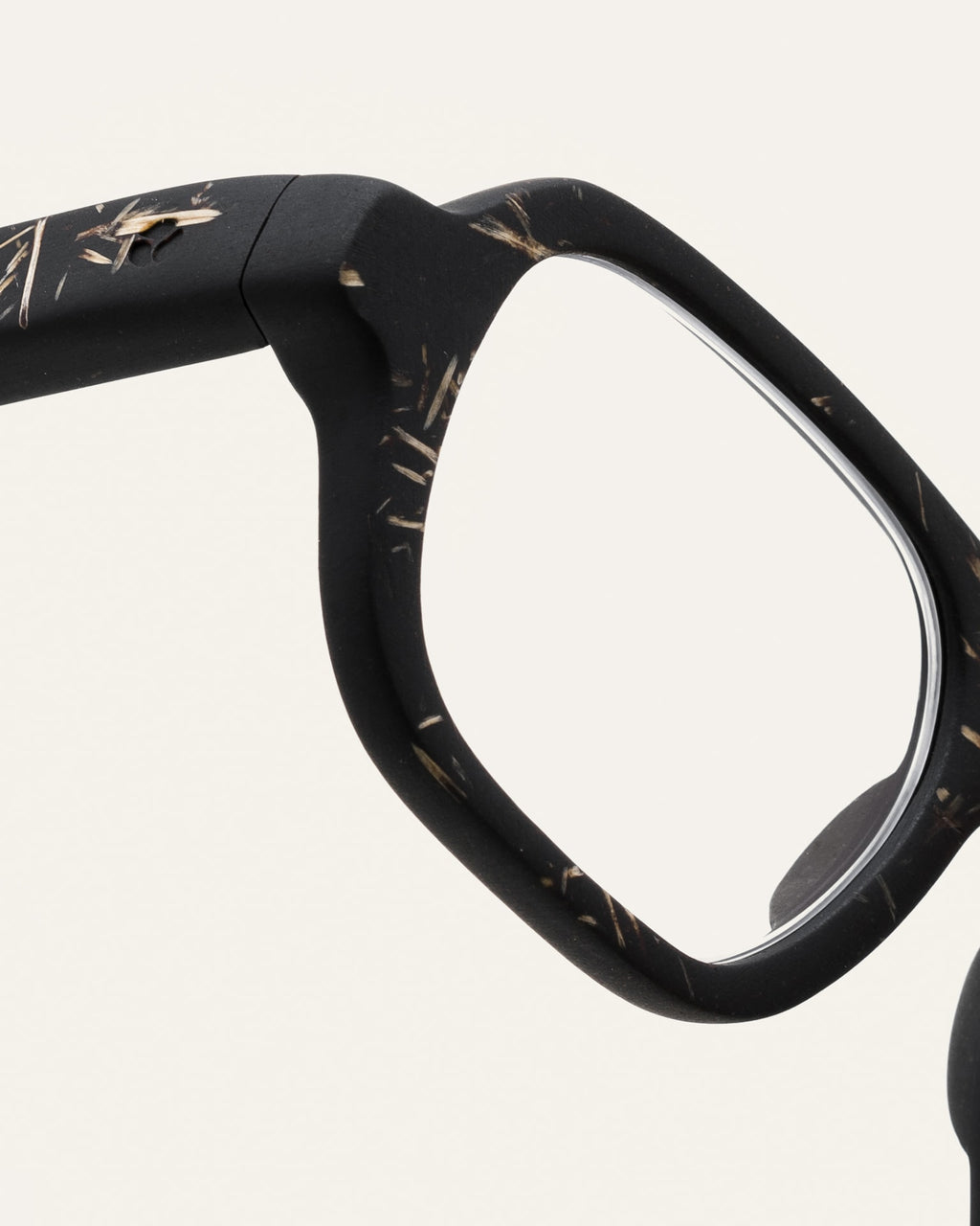 Close-up of black frame with natural flax details