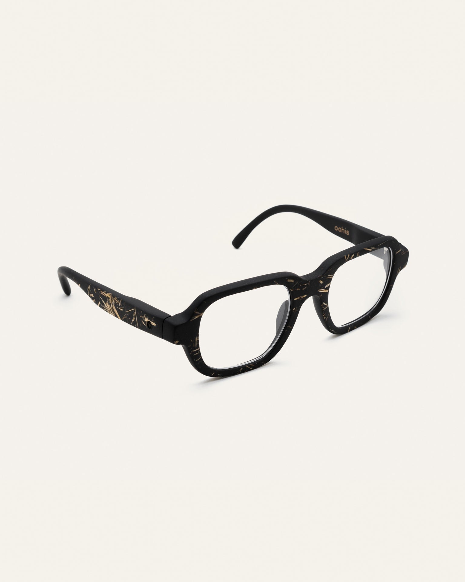 Angled view of black coffee-based frame with clear lenses.
