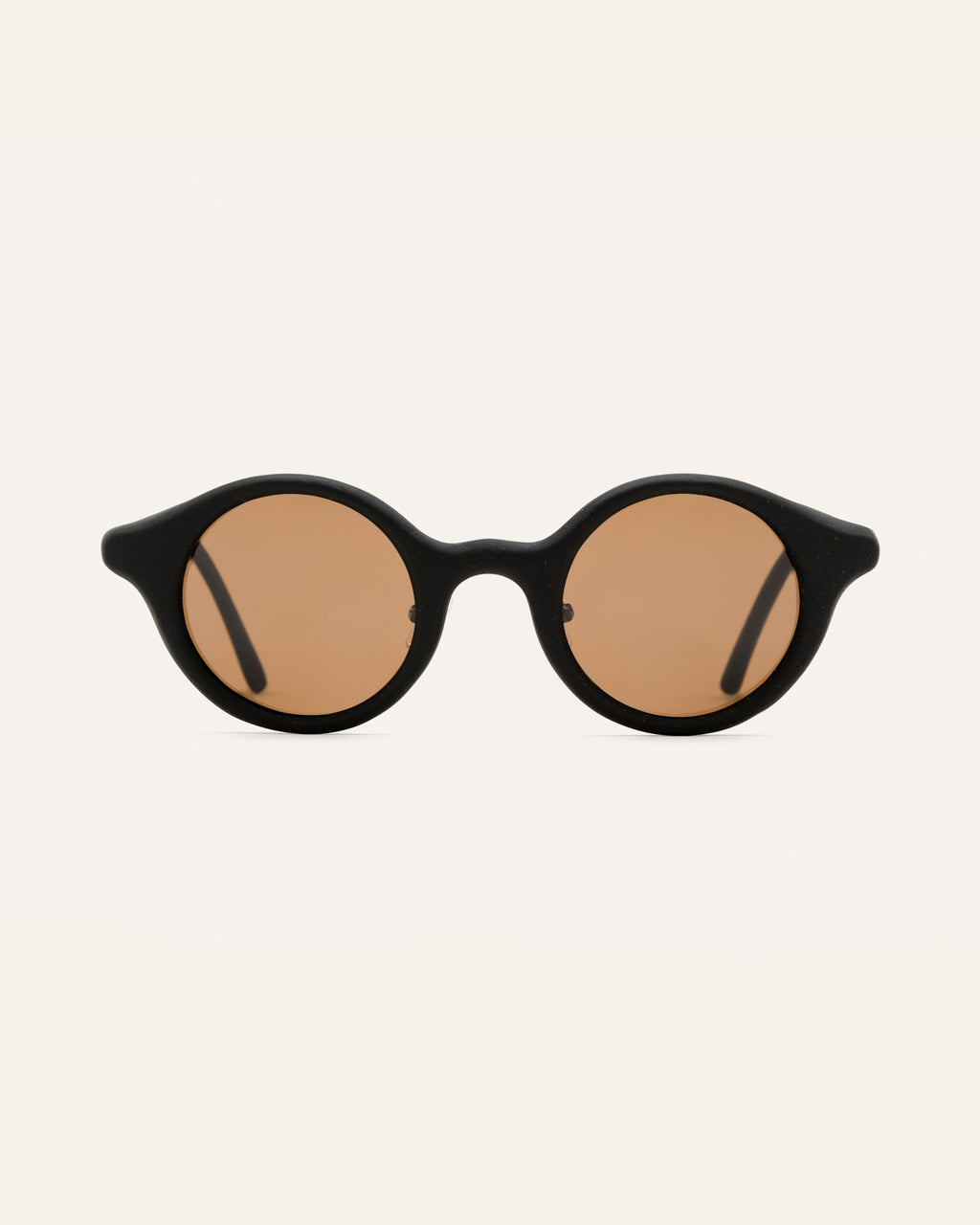Round black sunglasses with warm brown lenses, crafted from sustainable coffee-based materials for eco-conscious style.