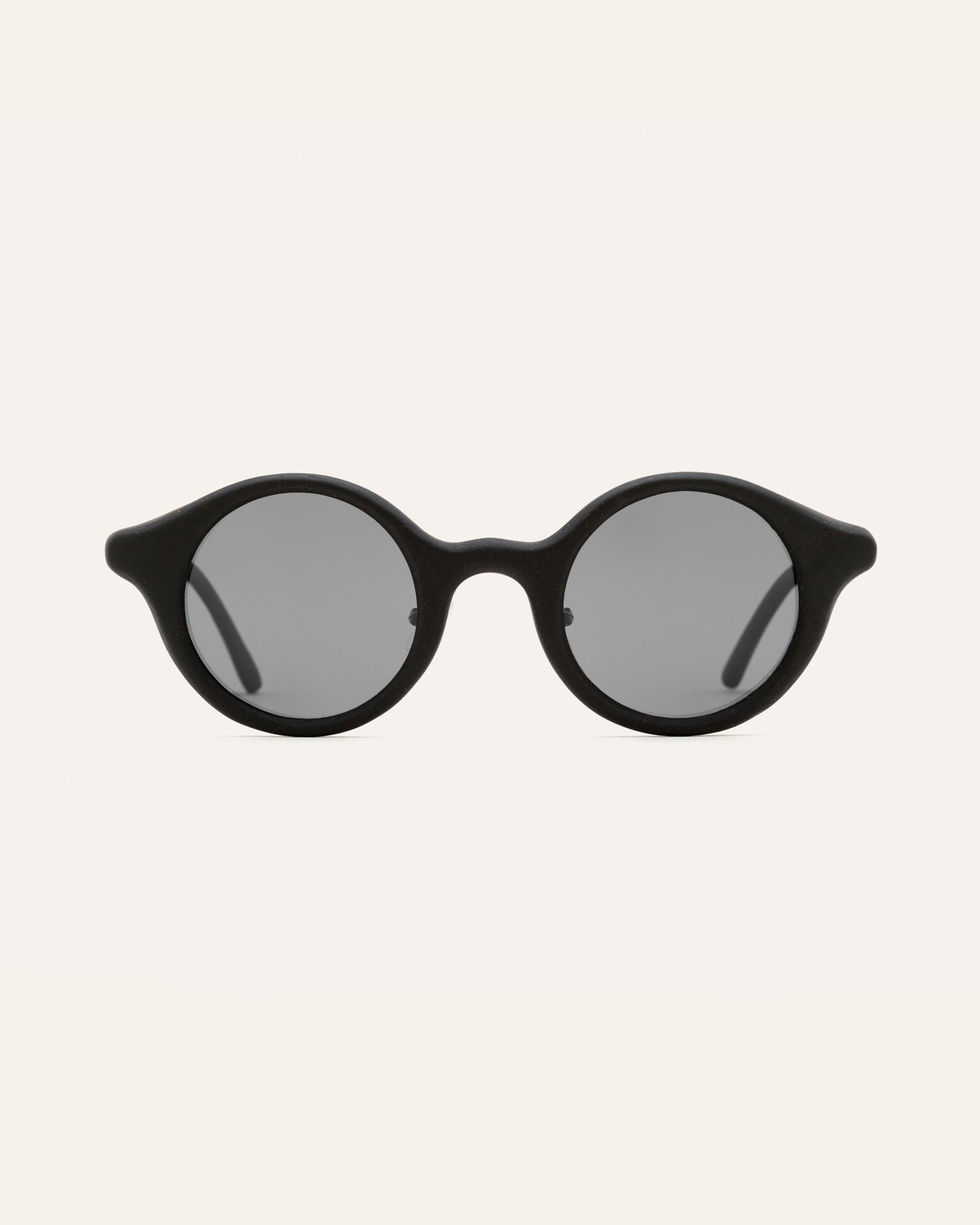 Round black sunglasses with gray lenses, designed for everyday comfort and style
