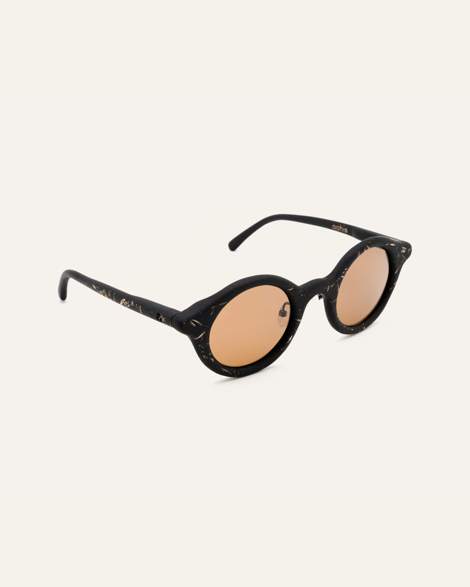 Side view of black sunglasses with brown lenses, featuring a lightweight frame and subtle flax accents