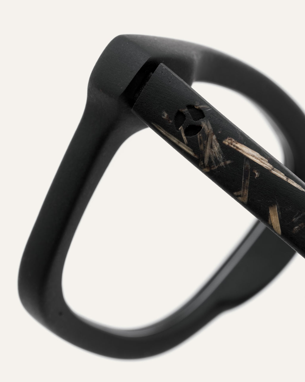 Close-up of Dandy optical frames, showcasing their coffee-based material and subtle flax-covered details on the temples