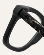 Close-up of Dandy optical frames, showcasing their coffee-based material and subtle flax-covered details on the temples