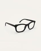 Angled view of Dandy optical frames with transparent lenses, showing their lightweight design and natural details
