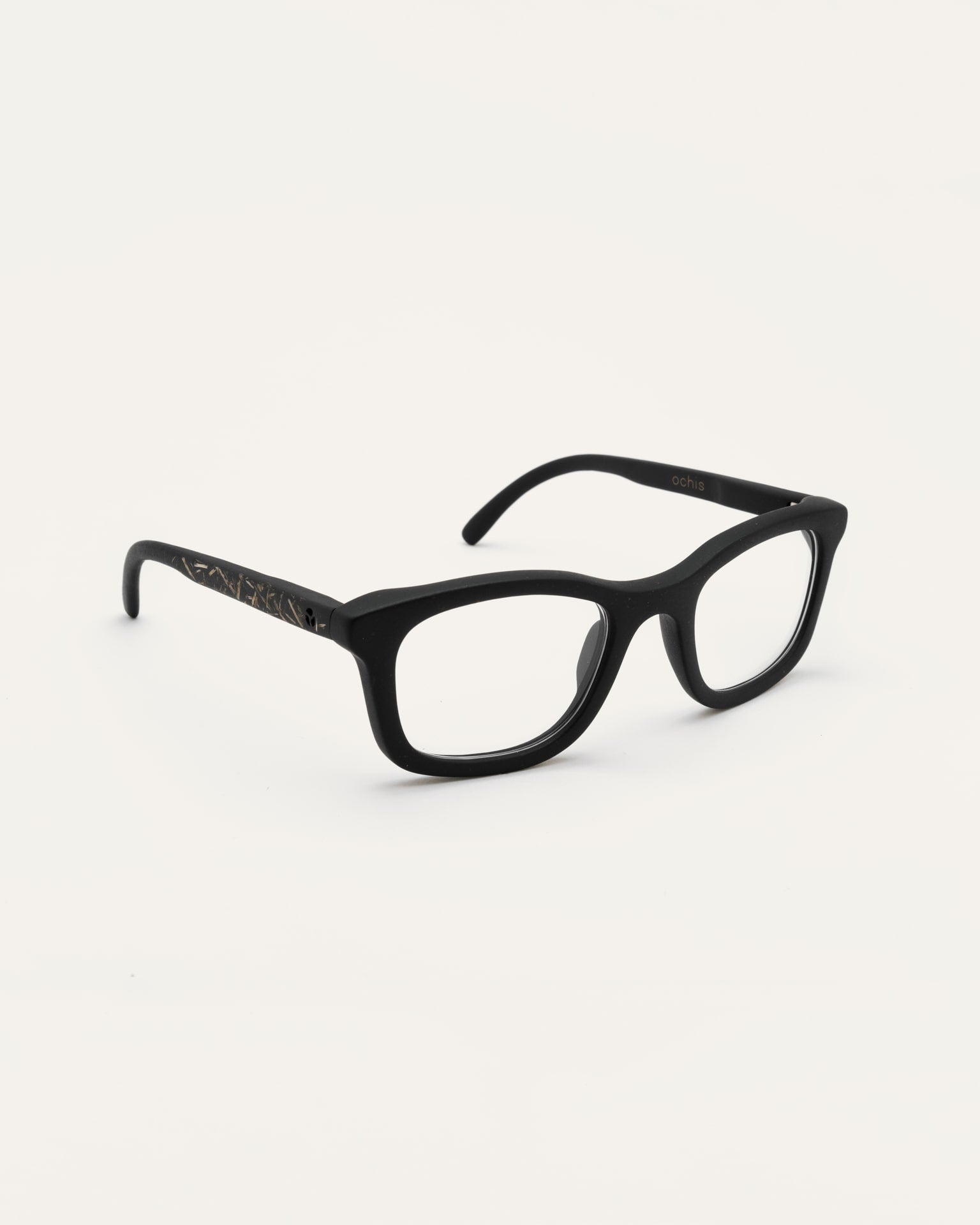 Angled view of Dandy optical frames with transparent lenses, showing their lightweight design and natural details