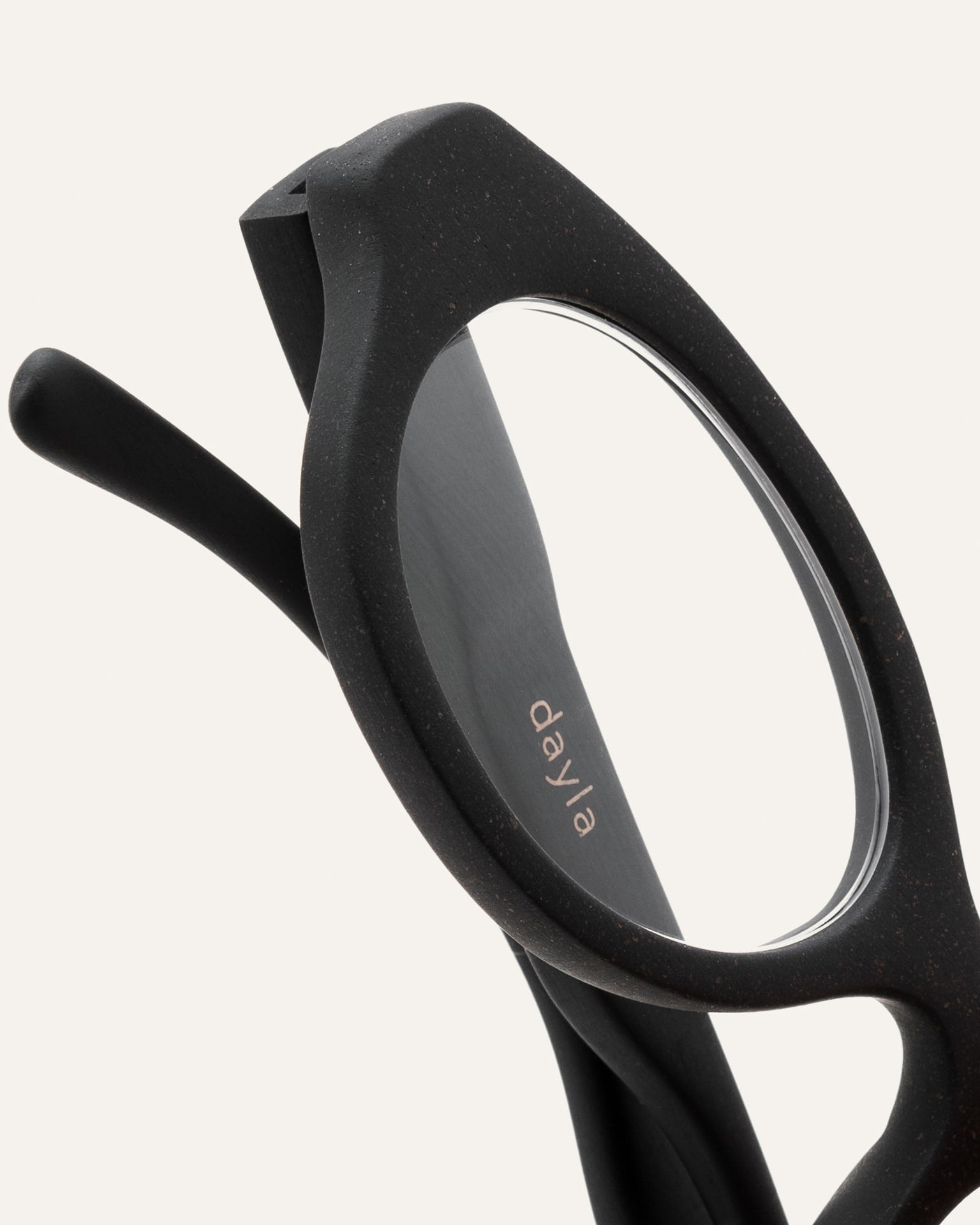Detailed view of the black oval coffee-based frame, highlighting its smooth finish and sustainable craftsmanship